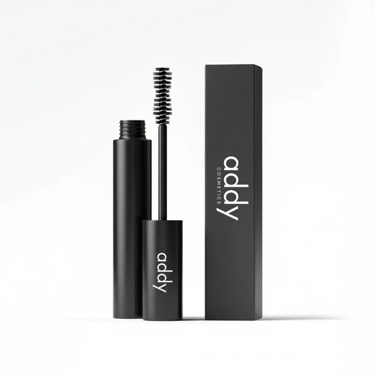 Black mascara with brush and packaging on a white background, featuring the brand &