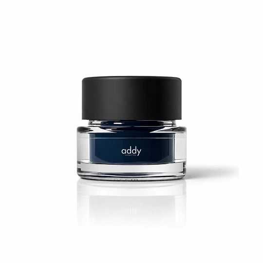 Clear jar with black lid labeled &