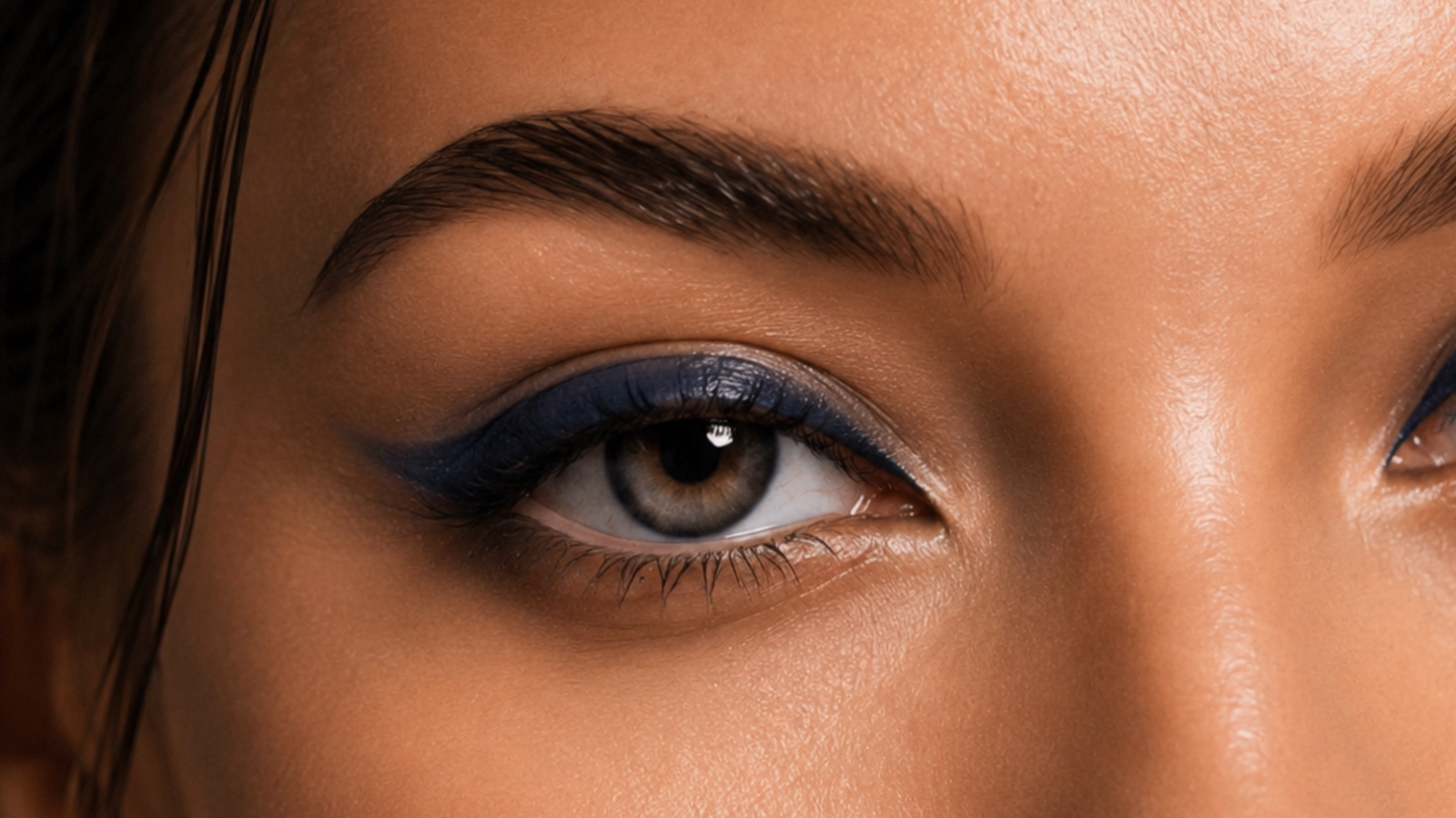 Close-up of a person's eye with blue eyeliner